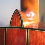 7 miter points on a 3 piece bloodwood Parlor guitar with  stained glass heel cap.