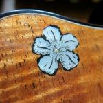 Engraved blossom inlay in MOP.  